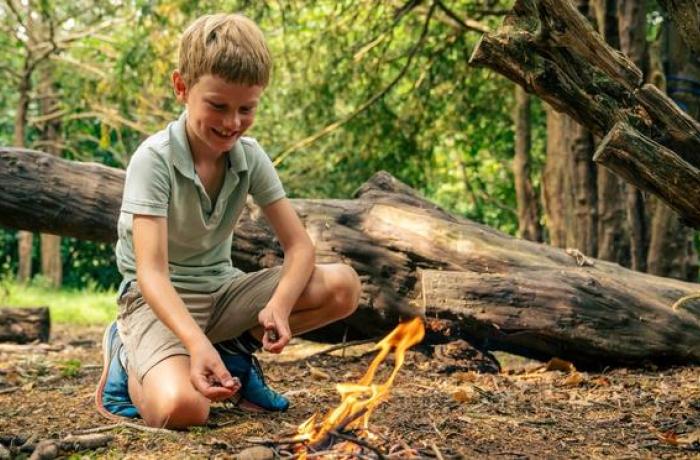 Boy lighting a fire