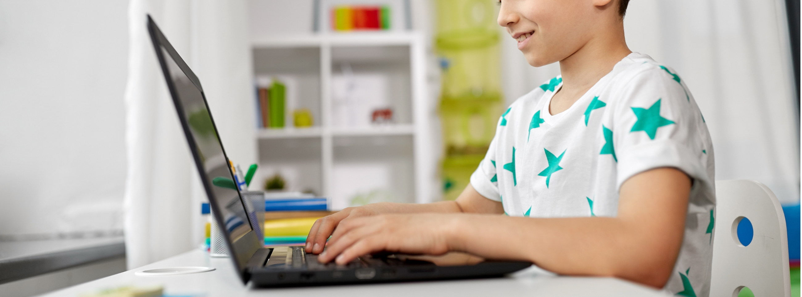 Boy on laptop smiling