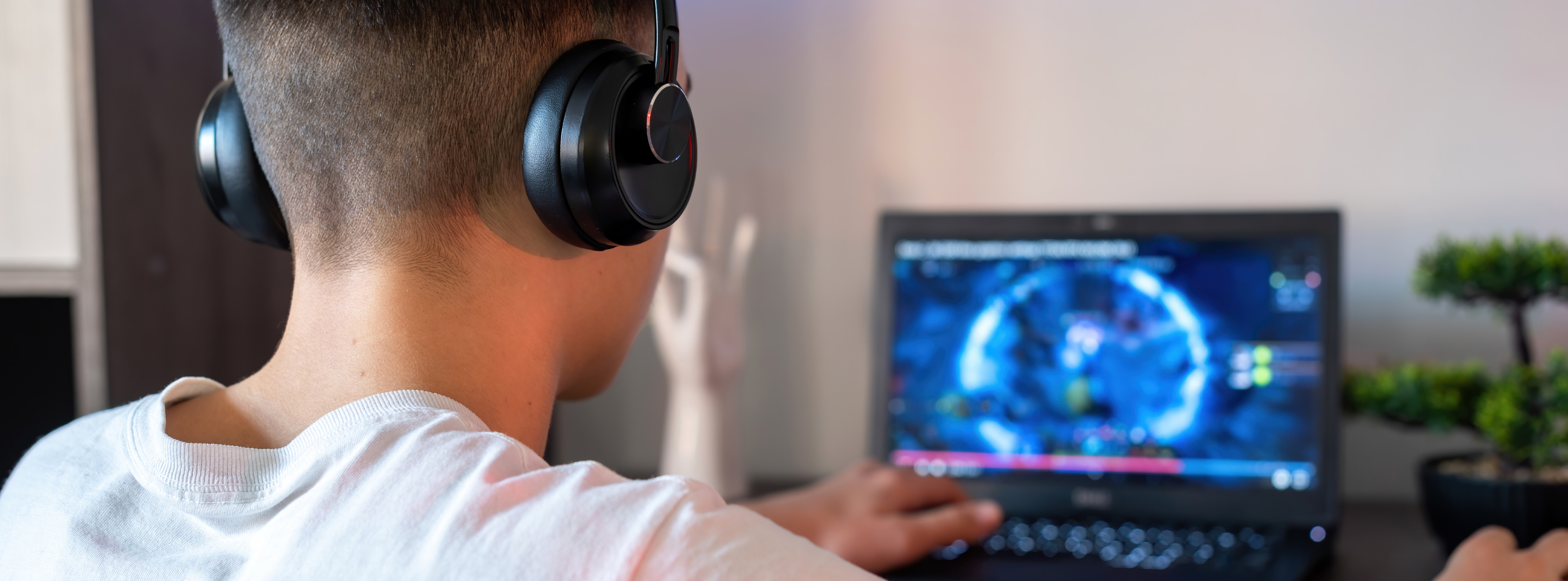 Boy at computer with headphones