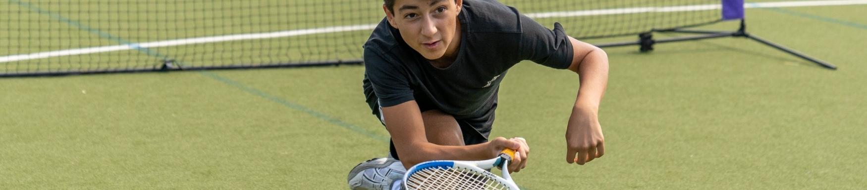 Boy playing tennis